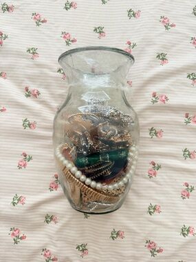 Clear Glass Vase Filled with Decorative Jewelry Accents